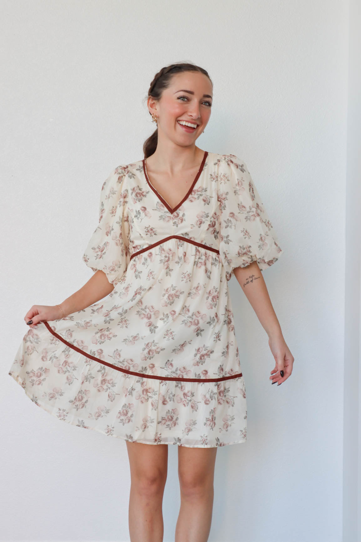 girl wearing cream and red floral dress