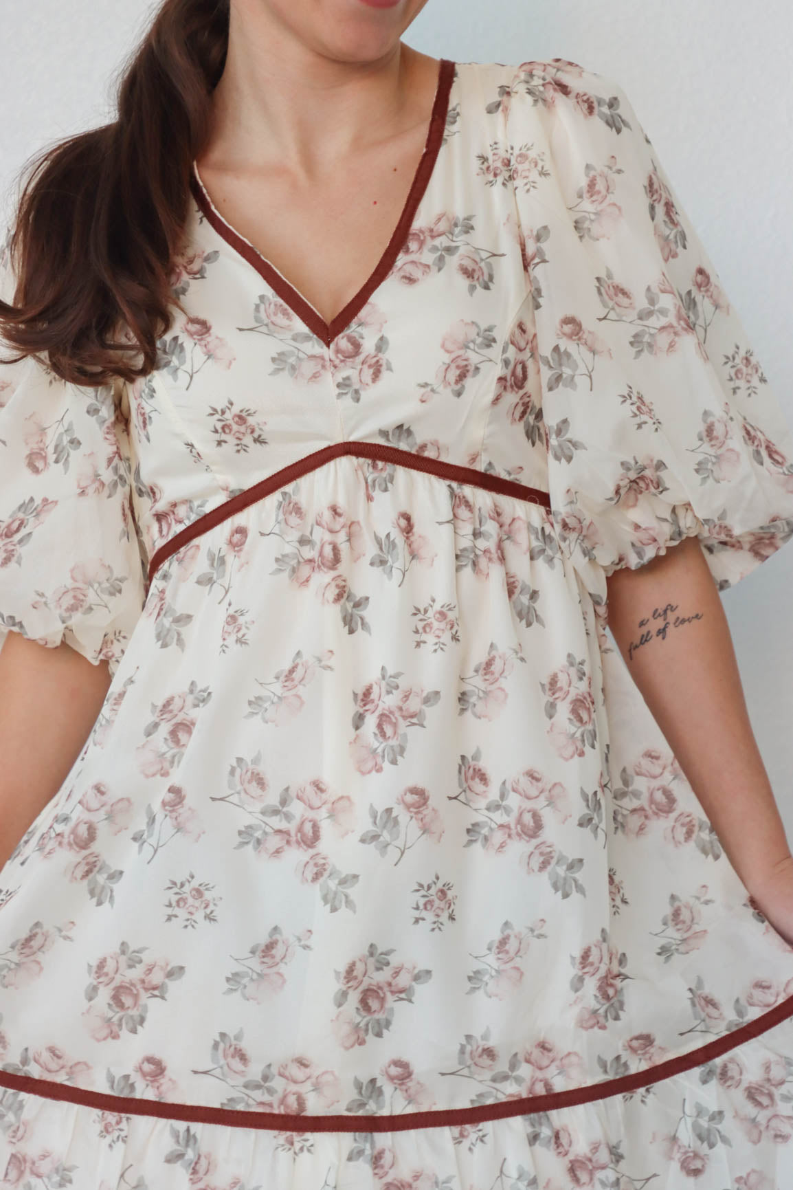 girl wearing cream and red floral dress