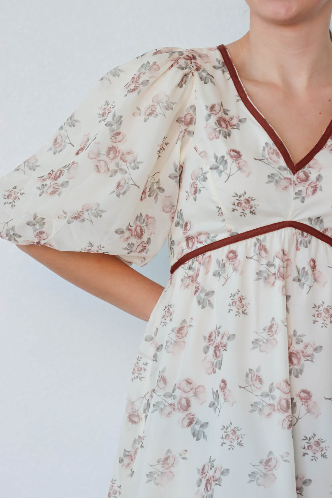 girl wearing cream and red floral dress