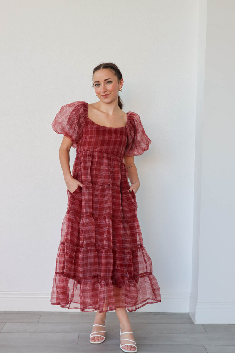 girl wearing long red plaid dress with puff sleeves