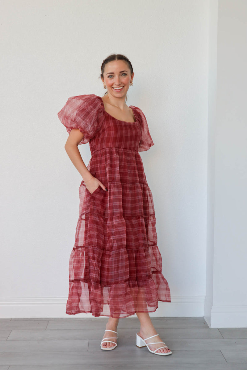 girl wearing long red plaid dress with puff sleeves