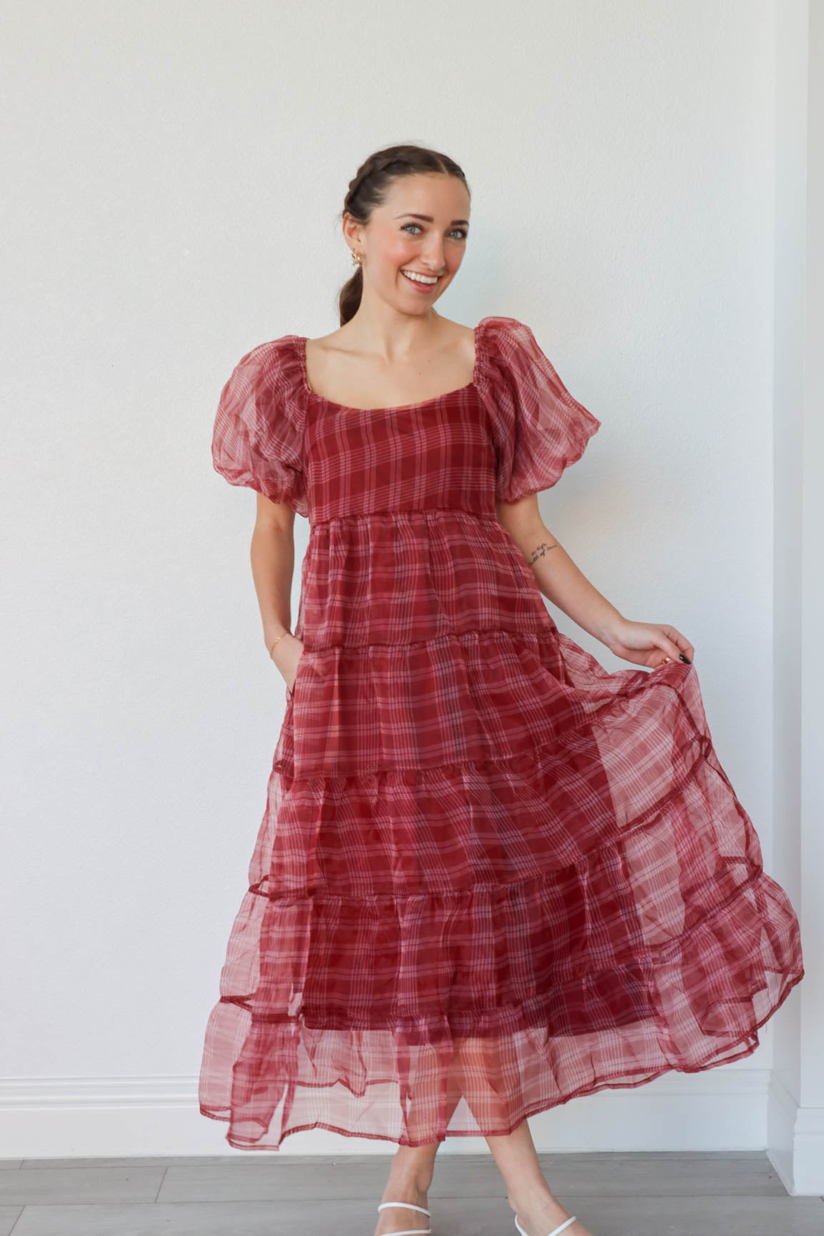 girl wearing long red plaid dress with puff sleeves