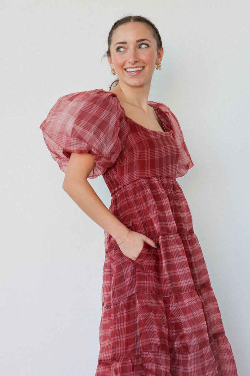 girl wearing long red plaid dress with puff sleeves