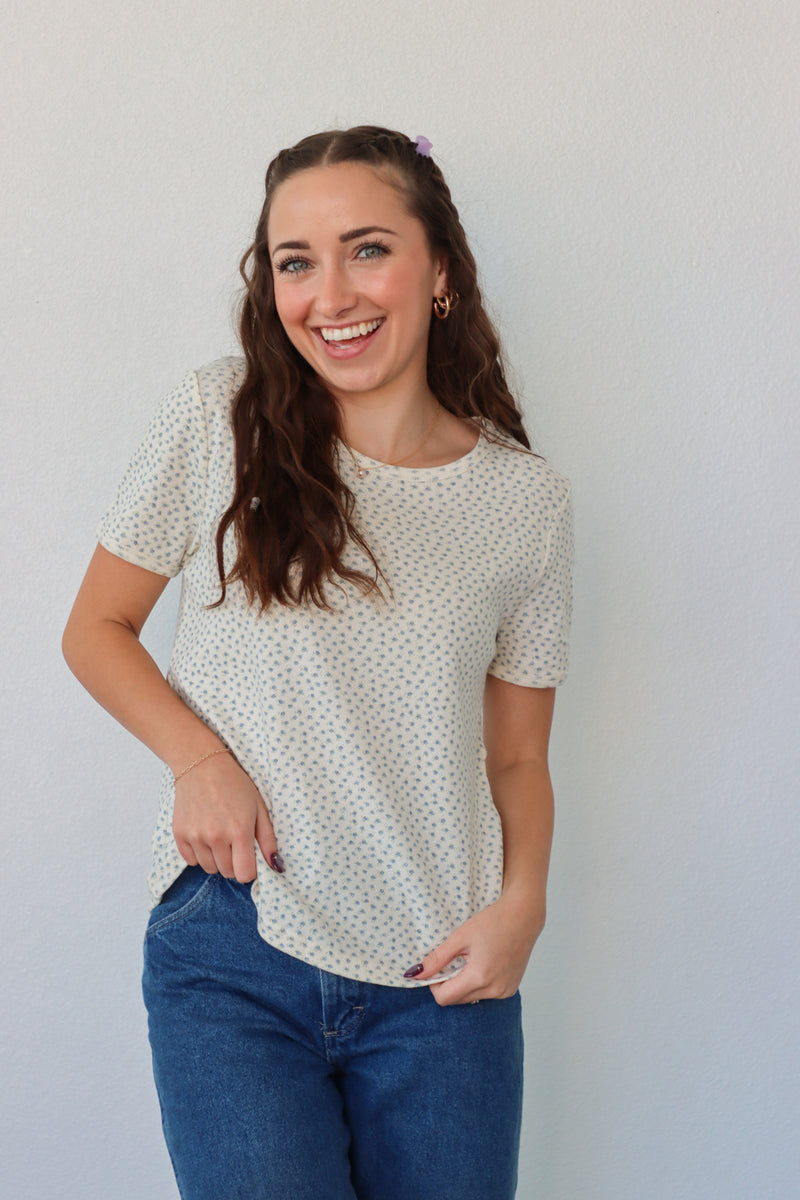 girl wearing white t-shirt with light blue floral pattern