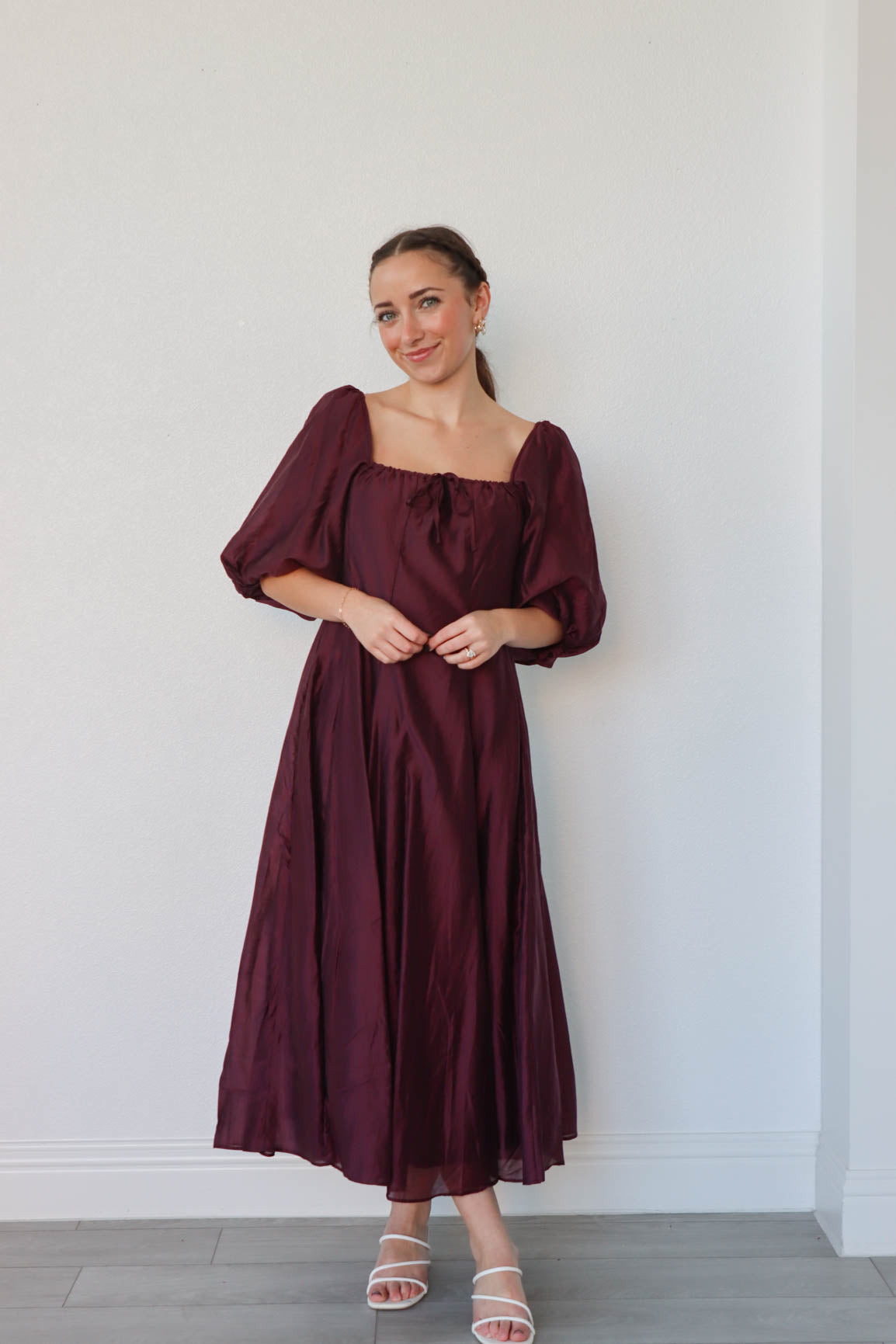 girl wearing long dark purple dress with 3/4 puff sleeves