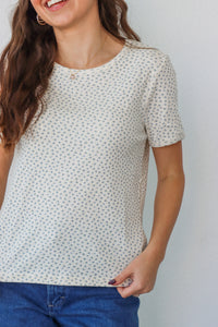 girl wearing white t-shirt with light blue floral pattern