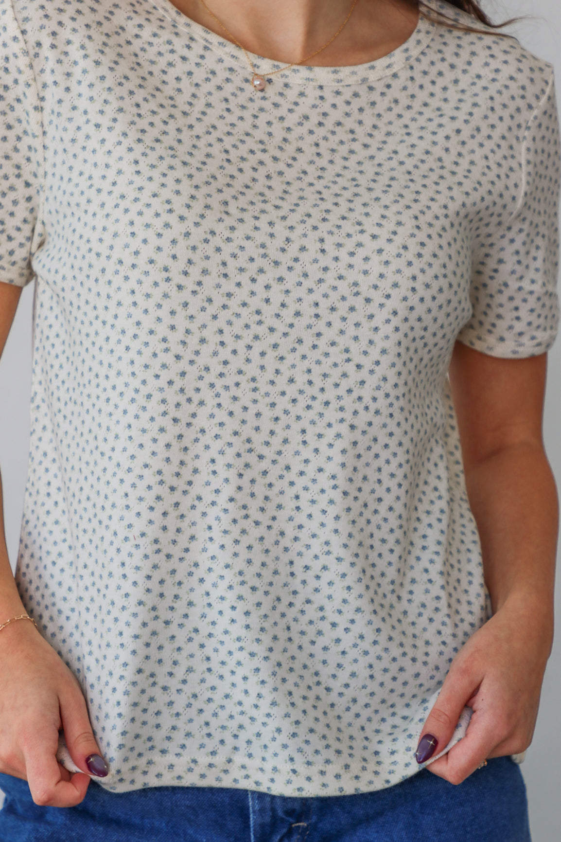 girl wearing white t-shirt with light blue floral pattern