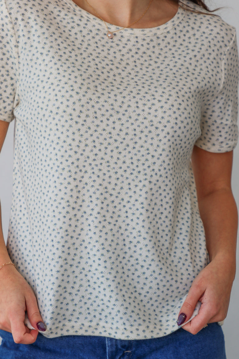 girl wearing white t-shirt with light blue floral pattern