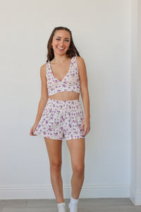 girl wearing white and purple floral pj set