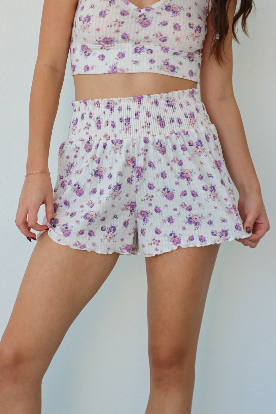 girl wearing white and purple floral pj set