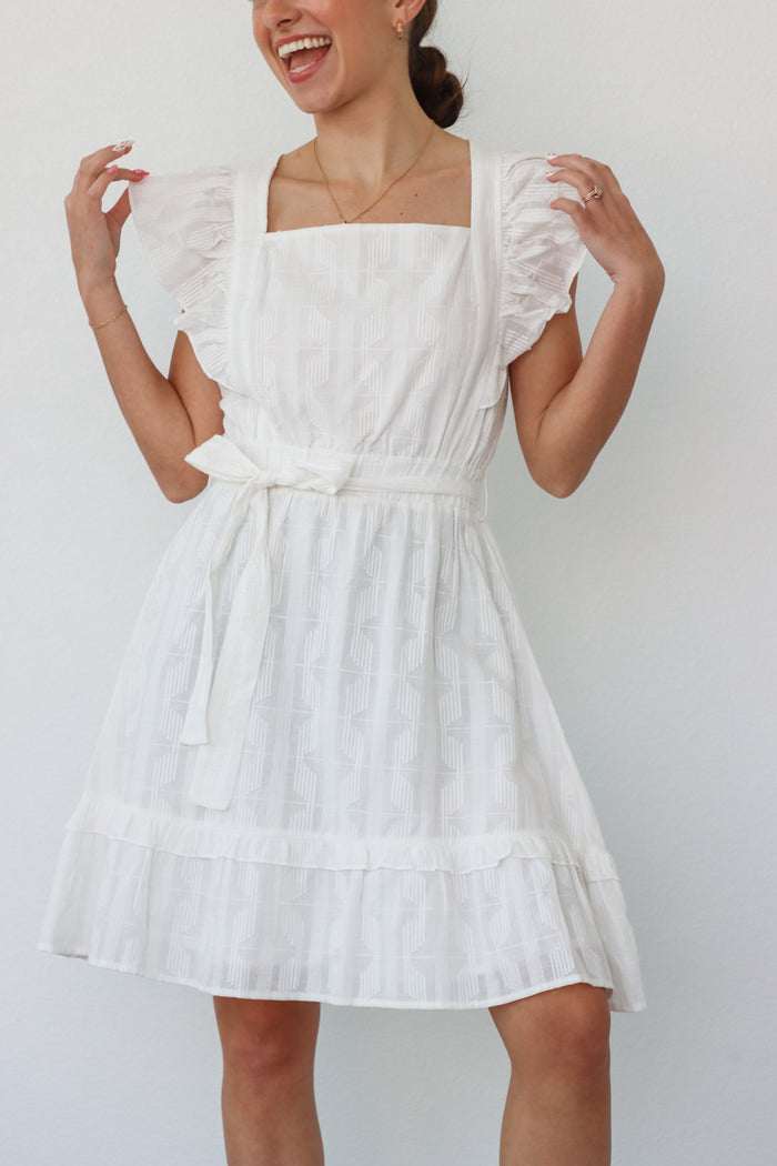 girl wearing white short sleeved dress
