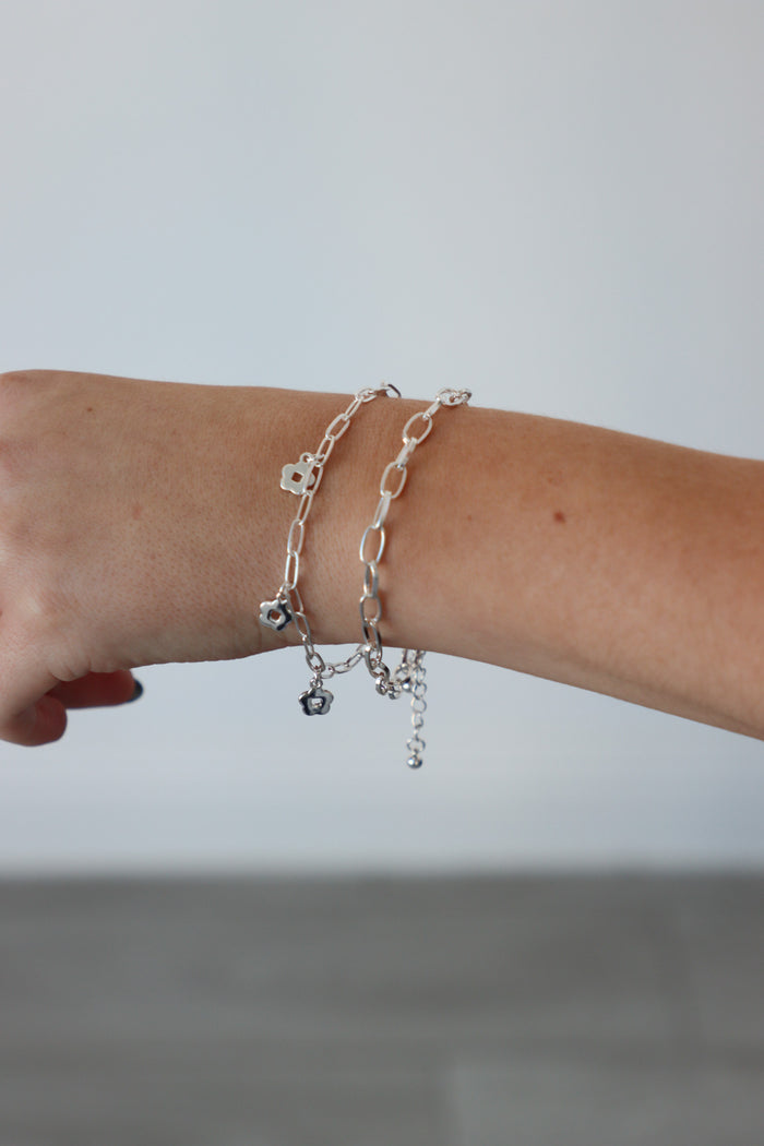 girl wearing silver chain flower bracelets
