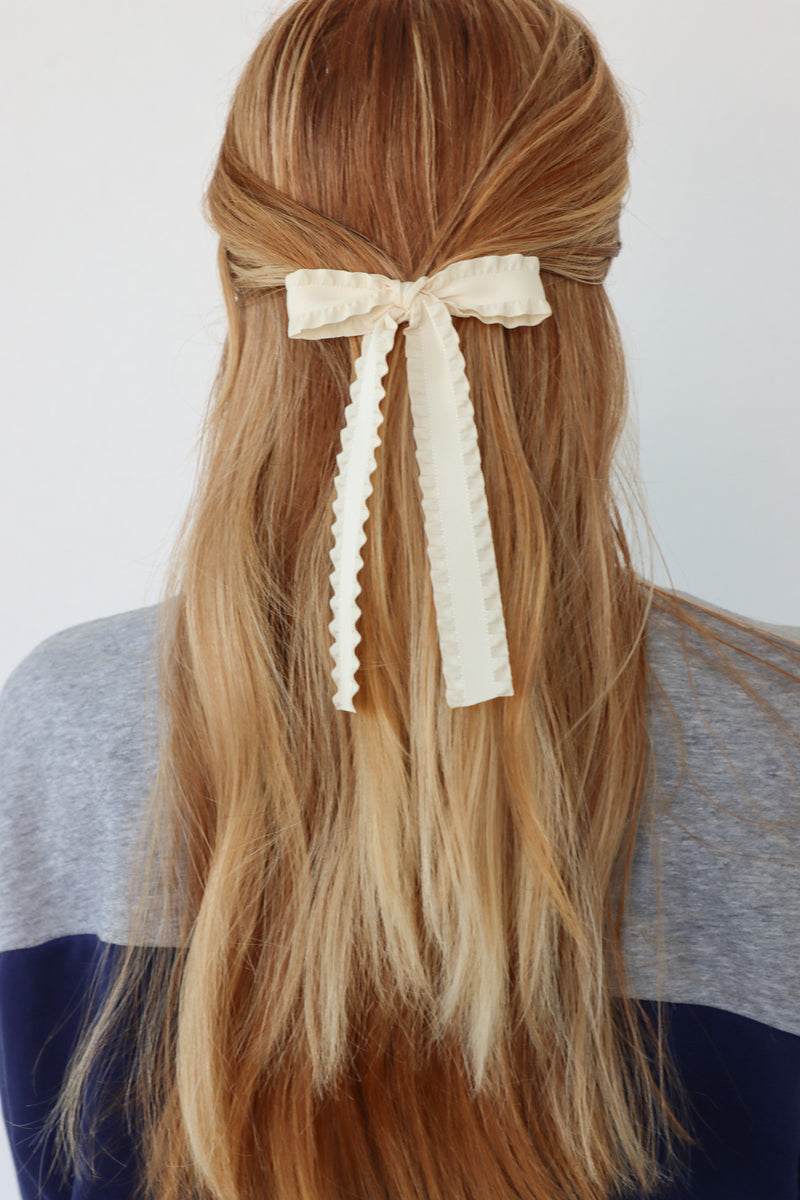 girl wearing cream hair bow