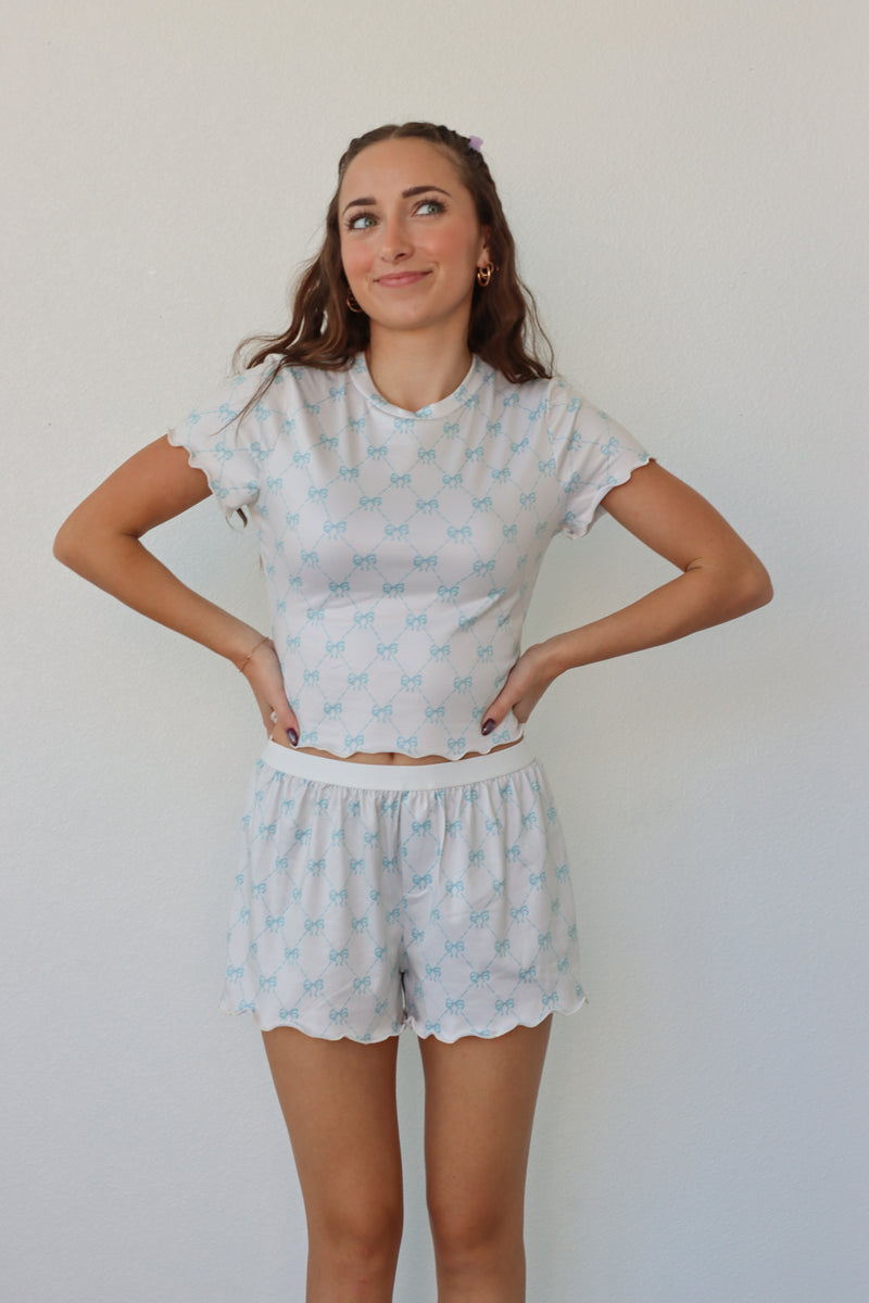 girl wearing white and light blue bow pj set