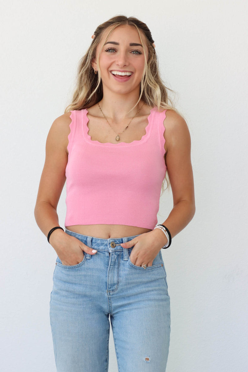 girl wearing pink tank top with scalloped straps