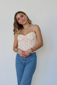 girl wearing cream and pink corset top