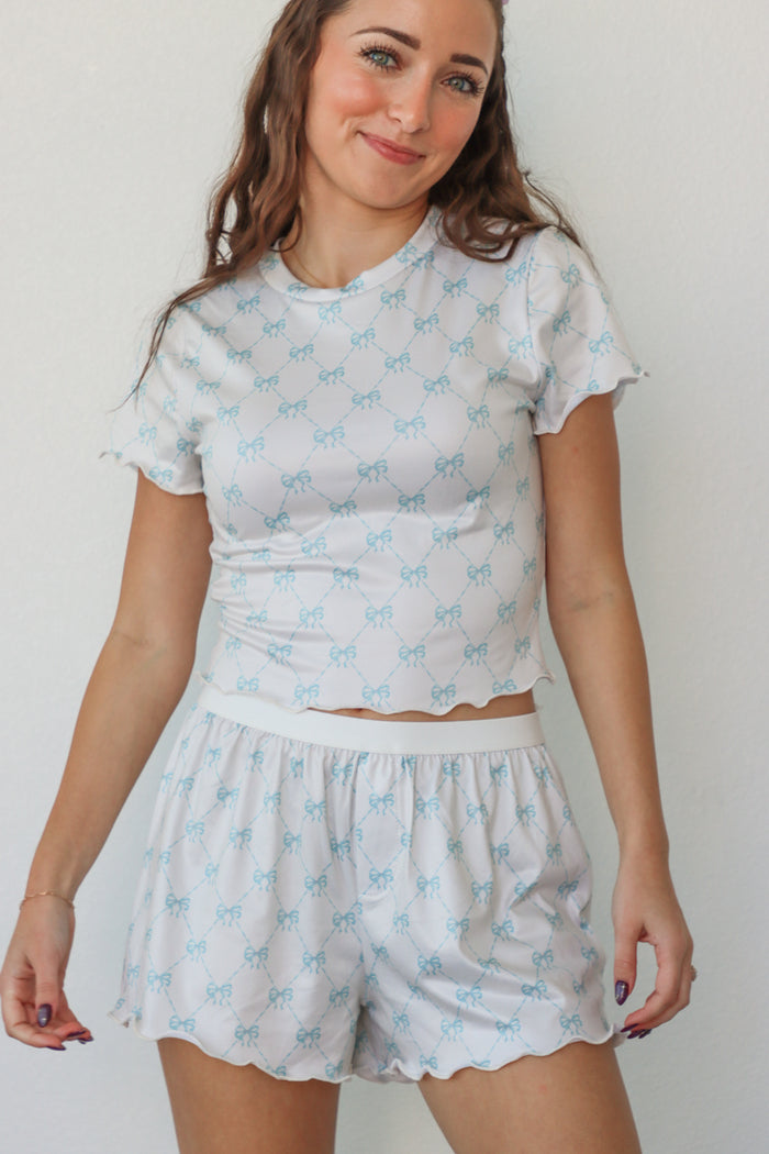 girl wearing white and light blue bow pj set