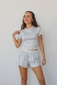 girl wearing white and light blue bow pj set