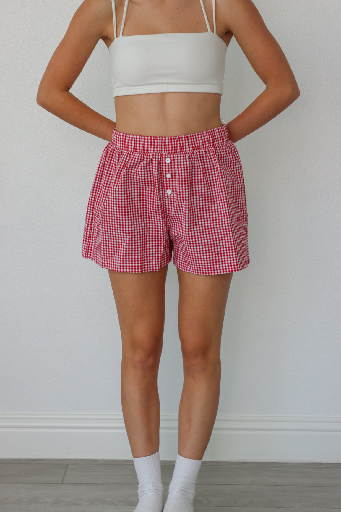 girl wearing red plaid boxer shorts