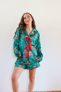girl wearing dark green silk teddy bear pj set