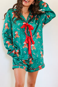 girl wearing dark green silk teddy bear pj set