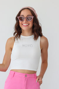 girl wearing white "xoxo" tank top