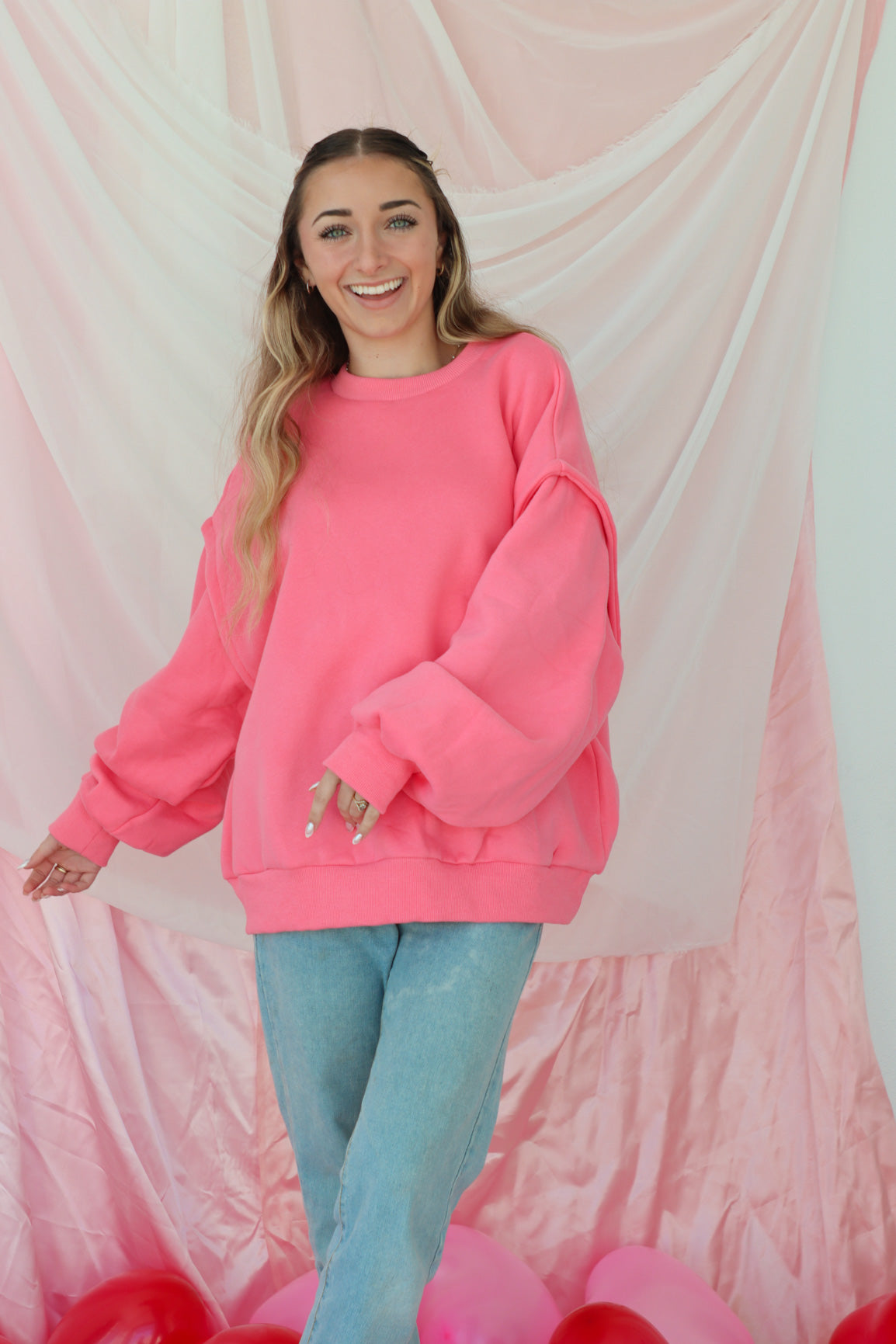 girl wearing hot pink crewneck sweatshirt