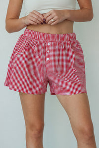 girl wearing red plaid boxer shorts