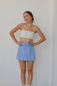 girl wearing periwinkle skort