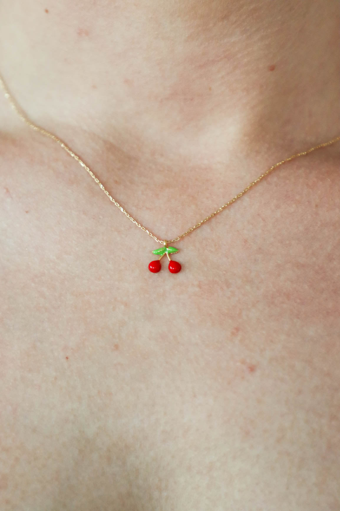 red cherry necklace with gold chain