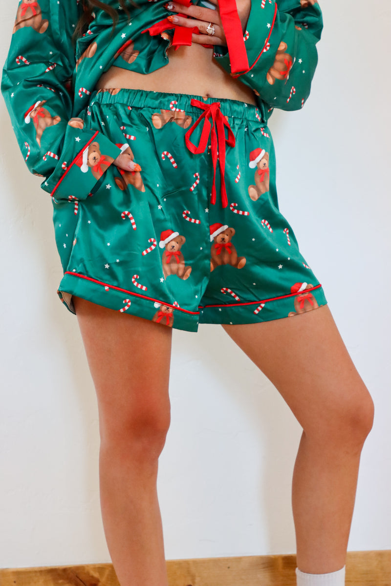 girl wearing dark green silk teddy bear pj set