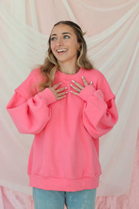 girl wearing hot pink crewneck sweatshirt