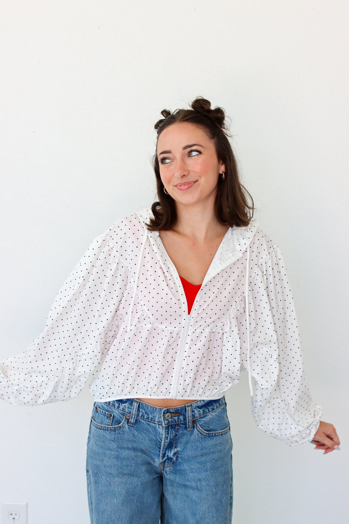 woman wearing a lightweight white polka dot jacket