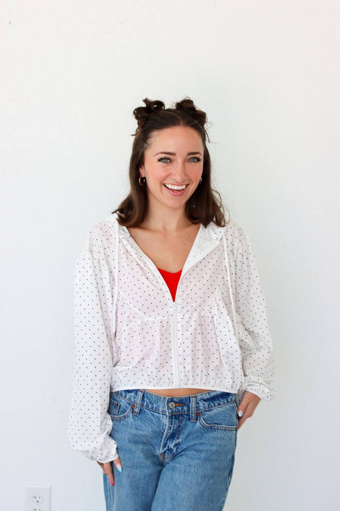 woman wearing a lightweight white polka dot jacket