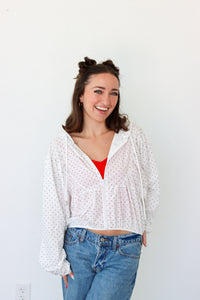 woman wearing a lightweight white polka dot jacket