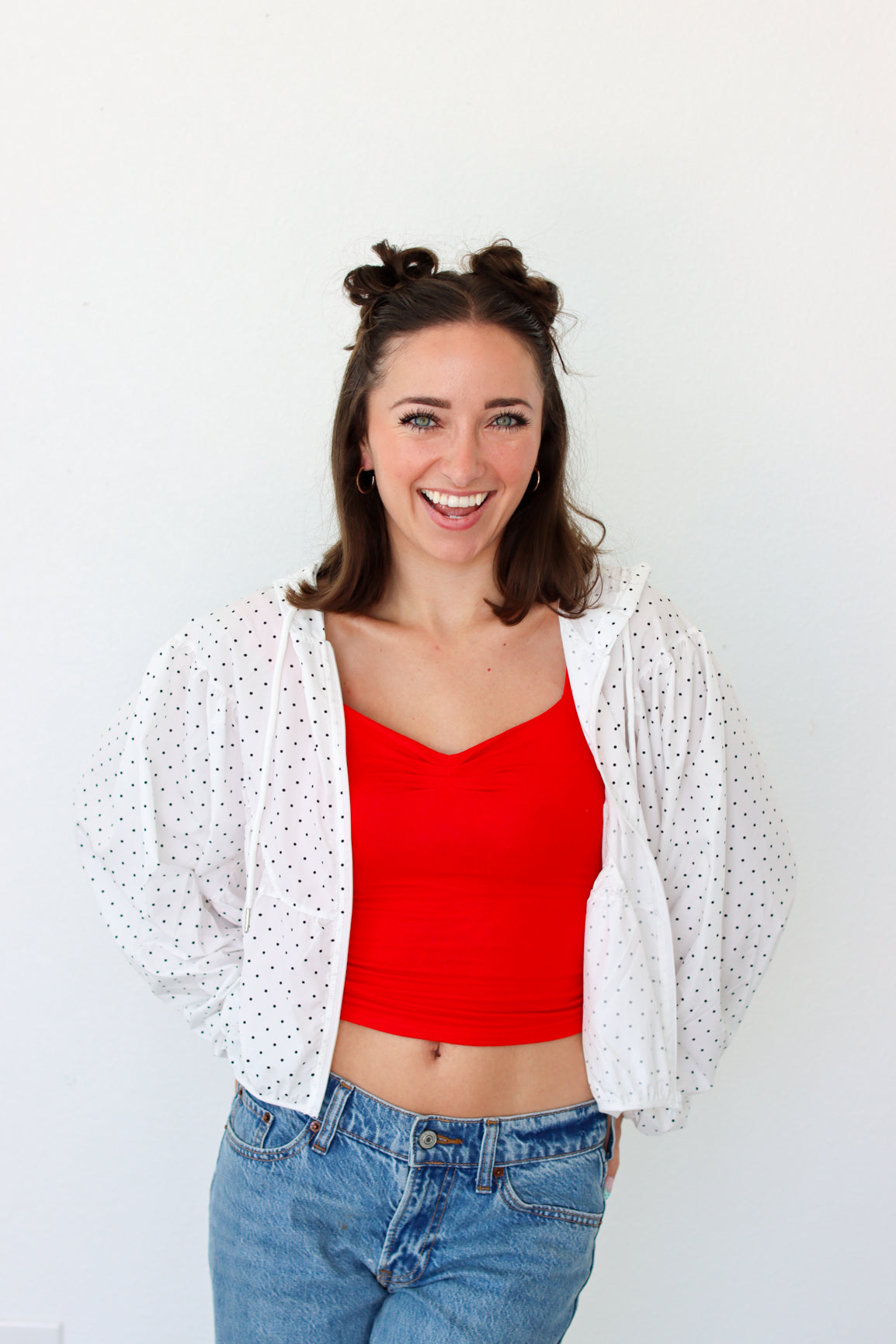 woman wearing a lightweight white polka dot jacket