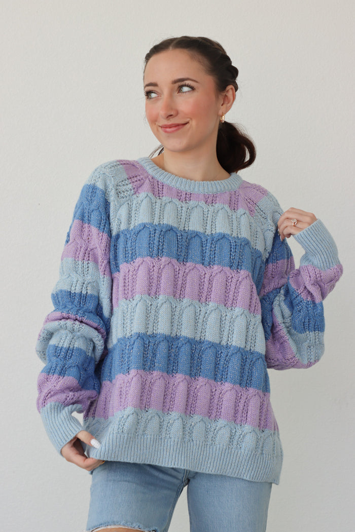 girl wearing blue and purple striped sweater
