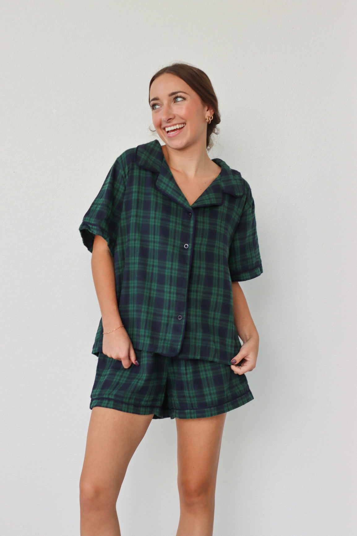 girl wearing dark green and navy plaid pajamas