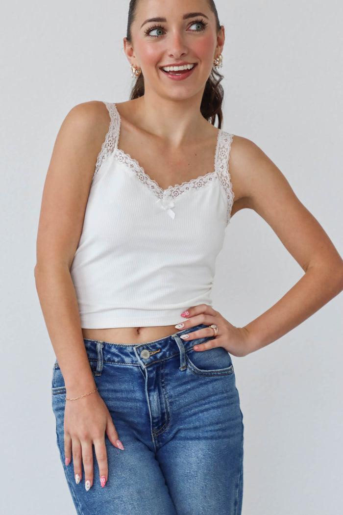 girl wearing white tank top with lace edges