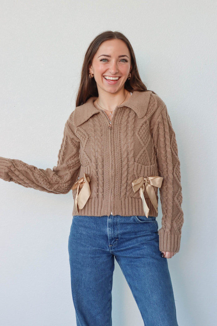 girl wearing brown zip up sweater