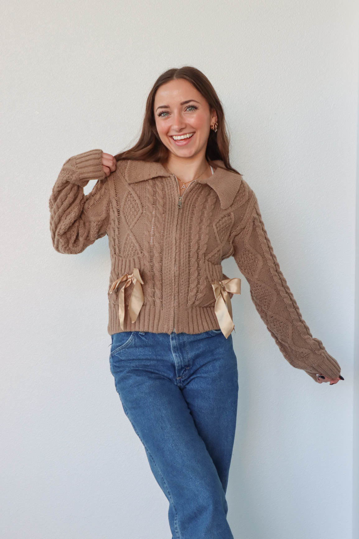 girl wearing brown zip up sweater