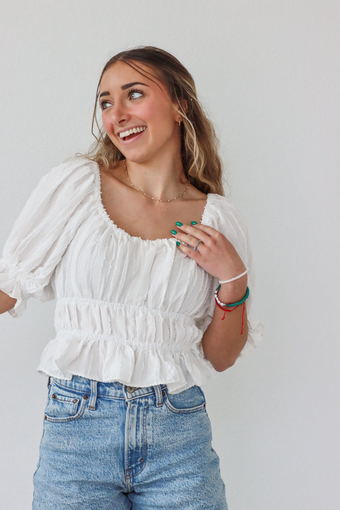 girl wearing white top with 3/4 sleeves