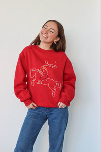 girl wearing red western embroidered crewneck