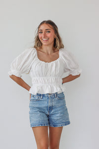 girl wearing white top with 3/4 sleeves