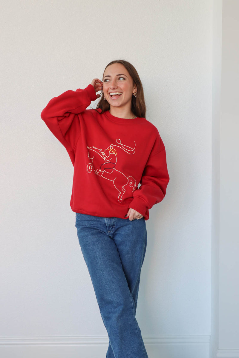 girl wearing red western embroidered crewneck