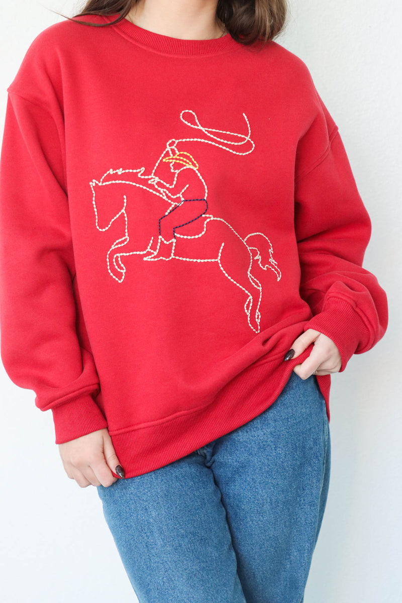 girl wearing red western embroidered crewneck