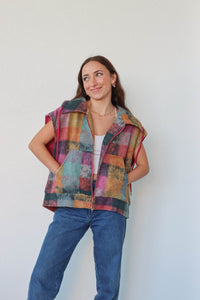 girl wearing multicolored plaid vest