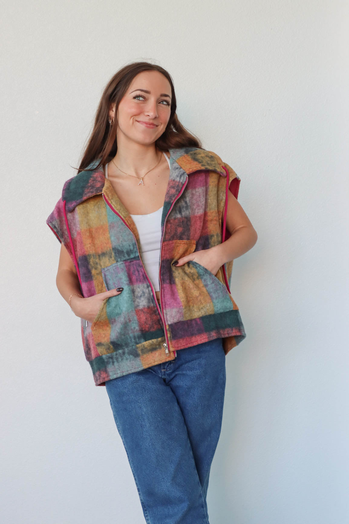 girl wearing multicolored plaid vest