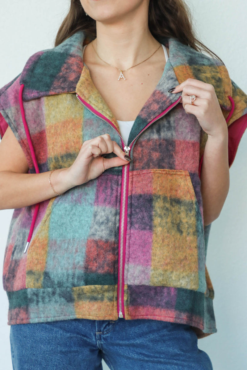 girl wearing multicolored plaid vest