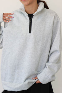 girl wearing gray quarter zip sweatshirt